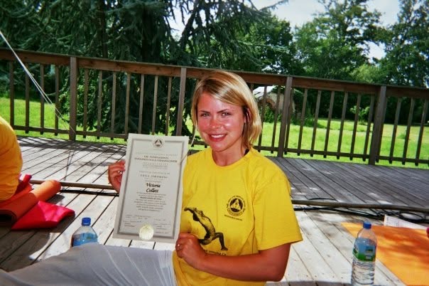 Victoria holding her Sivananda yoga training certificate